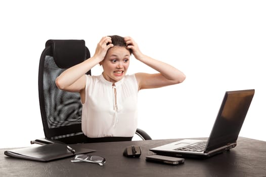 the business woman sits at office table with the laptop holding the head