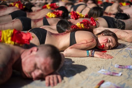SPAIN, Madrid: Anti-bullfighting protesters covered with red paint as if it is blood gather at Puerta del Sol square, in Madrid, on March 27, 2016 against bullfights. They have turned the iconic square of Puerta del Sol into a bullring. Protesters deman