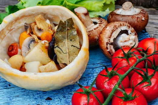 Vegetarian dish of baked mushrooms,potatoes and tomatoes for dinner