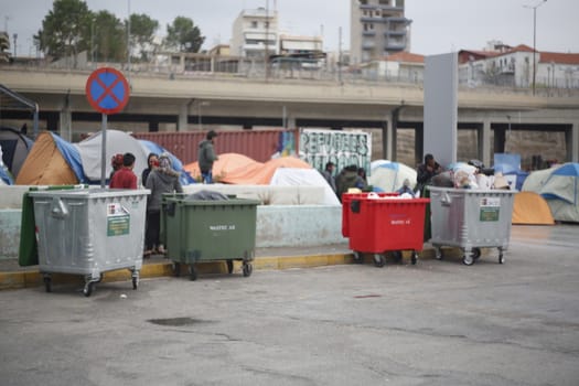 GREECE, Athens: Refugees continue to camp out under the rain, as thousands are still stranded at the Port of Piraeus in Athens, Greece on March 27, 2016. A deal between the European Union and Turkey has aimed to curb the influx of refugees to Greece, saying reception centers have become detention facilities. 