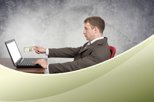 Businessman giving cash to laptop, internet concept