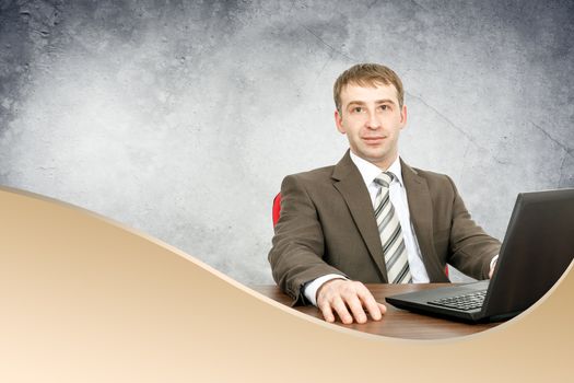 Businessman with laptop looking at camera, business concept