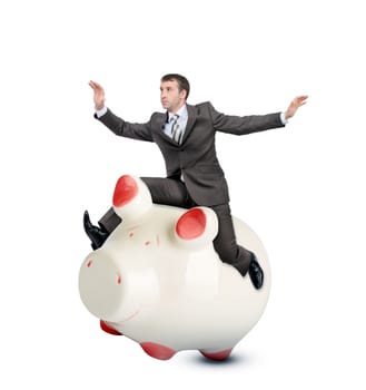 Businessman riding piggy bank isolated on white background