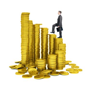 Businessman walking on gold coins piles isolated on white background