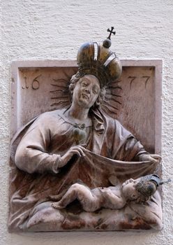 Virgin Mary with baby Jesus, statue on house facade Salzburg, Austria
