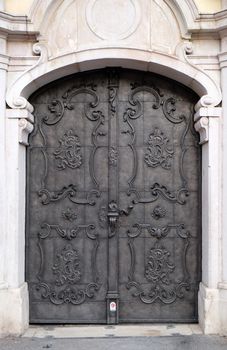Majestic medieval door with ornate metal pattern and stone columns in Salzburg