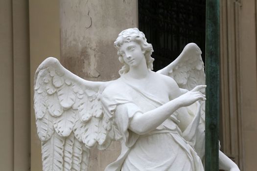 Angel statue in front of Karlskirche church in Vienna, Austria