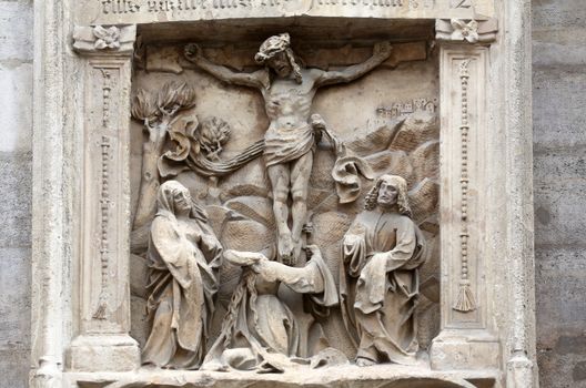 An old crucifixion relief sculpture outside St. Stephen's Cathedral in Vienna, Austria