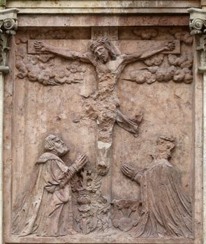 An old crucifixion relief sculpture outside St. Stephen's Cathedral in Vienna, Austria