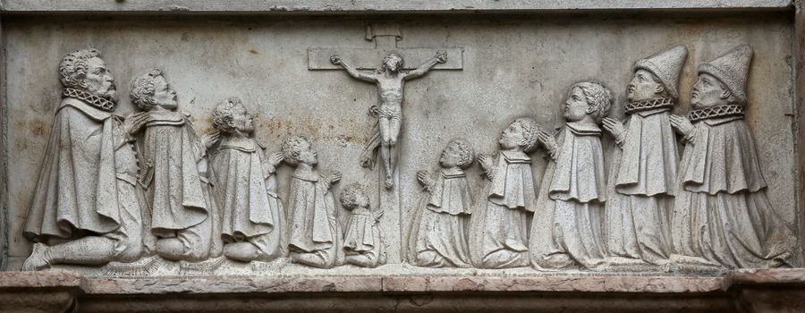 An old crucifixion relief sculpture outside St. Stephen's Cathedral in Vienna, Austria