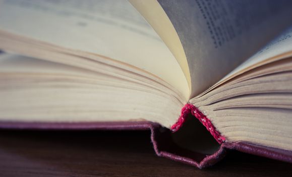 aged open book on the wooden table