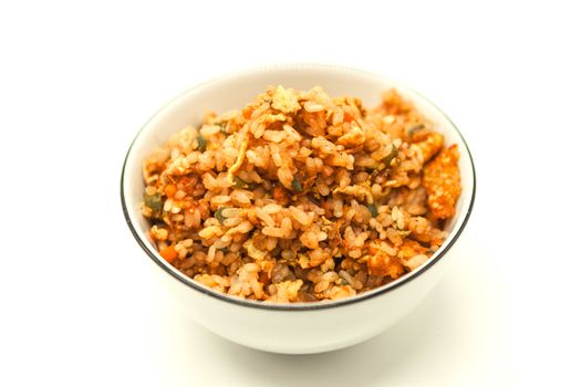 Fried Chinese rice with vegetables and egg, in a bowl on a white background. Chinese favourite garnish