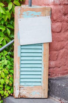 Age decorative weathered wooden window shutter.