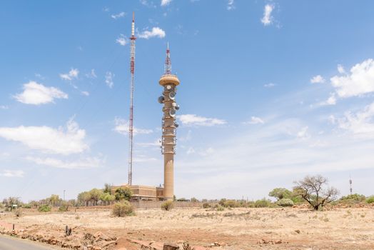 BLOEMFONTEIN, SOUTH AFRICA, DECEMBER 21, 2015: A microwave telecommunications tower and a TV and radio broadcast tower next to each other on Naval Hill. The broadcast tower was erected in 1963