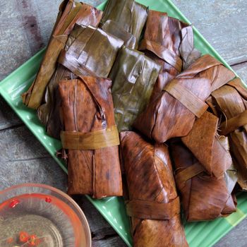 Vietnamese food, a special street food from Hue cuisine, make from rice flour with meat, shrimp, pack with banana leaf, call banh nam, banh bot loc, a famous Vietnam food