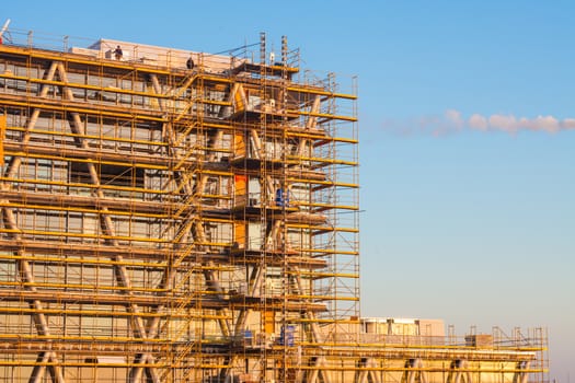 Modern building under construction with blue sky