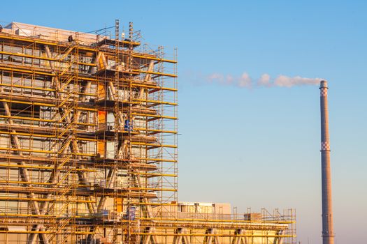 Modern building under construction with blue sky