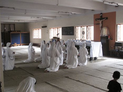 Sisters of Mother Teresa's Missionaries of Charity in prayer in the chapel of the Mother House, Kolkata, India