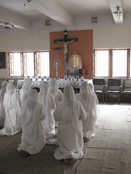 Sisters of Mother Teresa's Missionaries of Charity in prayer in the chapel of the Mother House, Kolkata, India
