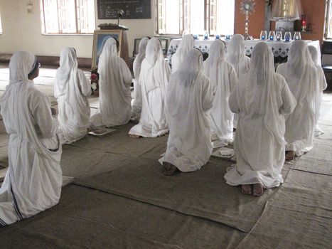 Sisters of Mother Teresa's Missionaries of Charity in prayer in the chapel of the Mother House, Kolkata, India
