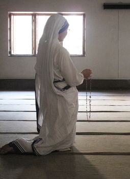 Sisters of Mother Teresa's Missionaries of Charity in prayer in the chapel of the Mother House, Kolkata, India