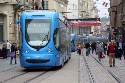 Blue city trams stay in a traffic jam in the city center in Zagreb, Croatia
