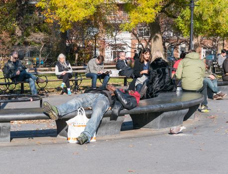 Manhattan, New York - December 06, 2015: Lazy Sunday afternoon in Washington Square Park.