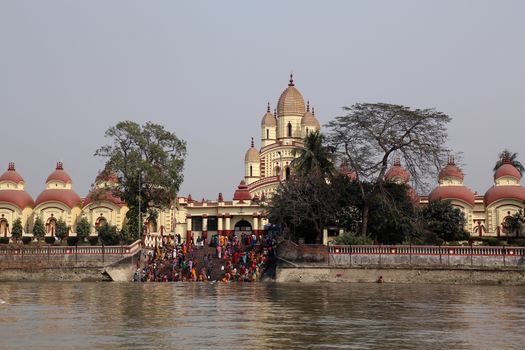Hindu people bathing in the ghat near the Dakshineswar Kali Temple in Kolkata, West Bengal, India