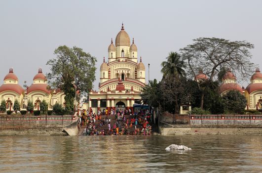 Hindu people bathing in the ghat near the Dakshineswar Kali Temple in Kolkata, West Bengal, India
