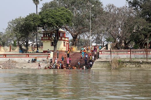 Hindu people bathing in the ghat near the Dakshineswar Kali Temple in Kolkata, West Bengal, India
