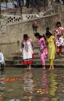 Hindu people bathing in the ghat near the Dakshineswar Kali Temple in Kolkata, West Bengal, India