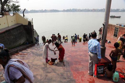 Hindu people bathing in the ghat near the Dakshineswar Kali Temple in Kolkata, West Bengal, India