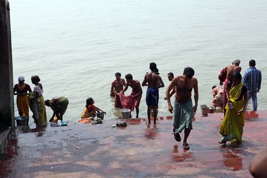 Hindu people bathing in the ghat near the Dakshineswar Kali Temple in Kolkata, West Bengal, India