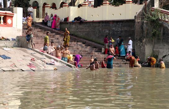 Hindu people bathing in the ghat near the Dakshineswar Kali Temple in Kolkata, West Bengal, India