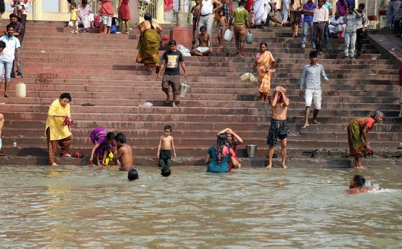 Hindu people bathing in the ghat near the Dakshineswar Kali Temple in Kolkata, West Bengal, India
