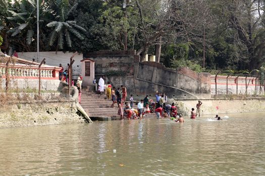 Hindu people bathing in the ghat near the Dakshineswar Kali Temple in Kolkata, West Bengal, India