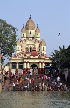 Hindu people bathing in the ghat near the Dakshineswar Kali Temple in Kolkata, West Bengal, India