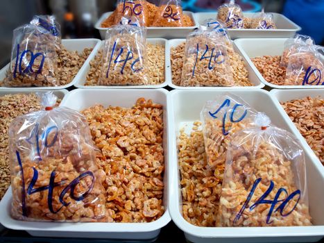 Heap dried shrimps for sell with sale price on package at market