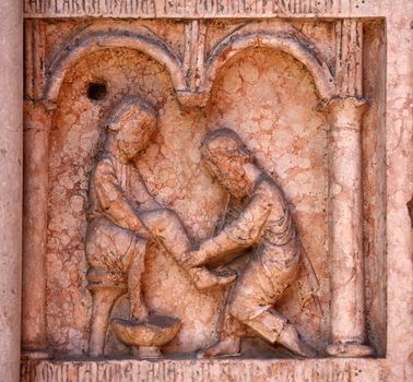 Christ Performing Works of Mercy relief at the baptistry from Benedetto Antelami, Parma, Emilia Romagna, Italy