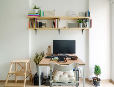 Home office working space. wooden shelf with white wall