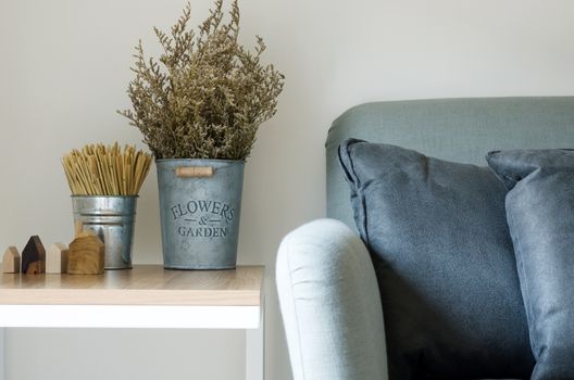 Modern sofa with dry flower in pot decorated on side table