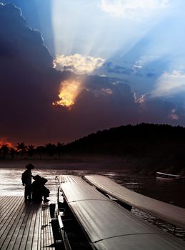 locals on pier and sky over Khwae Yai river