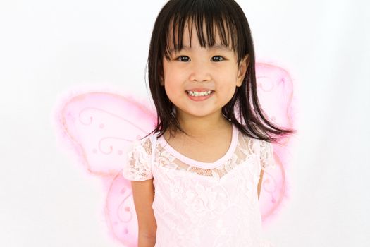 Chinese little girl wearing butterfly custome in plain white background