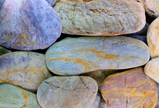 Pebbles from beach sites around the UK in arrangements.