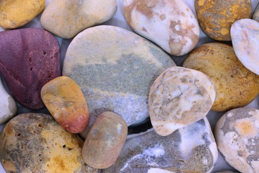 Pebbles from beach sites around the UK in arrangements.