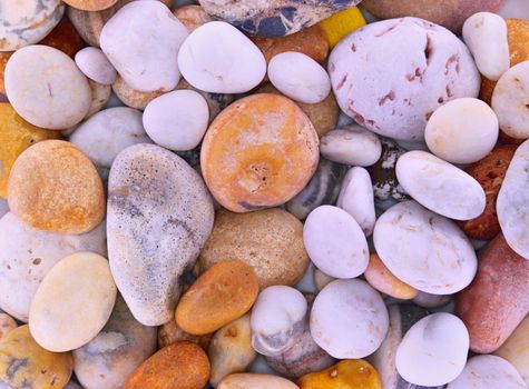 Pebbles from beach sites around the UK in arrangements.