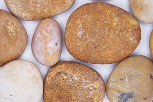 Pebbles from beach sites around the UK in arrangements.