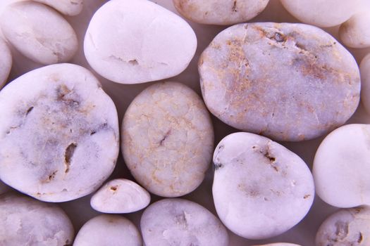 Pebbles from beach sites around the UK in arrangements.