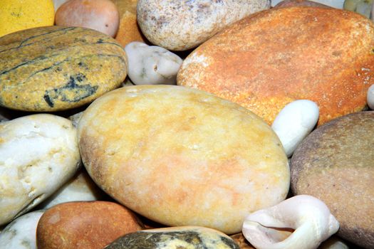 Pebbles from beach sites around the UK in arrangements.