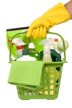 Vertical shot of a yellow gloved hand carrying a basket of green environmentally safe cleaning supplies.
